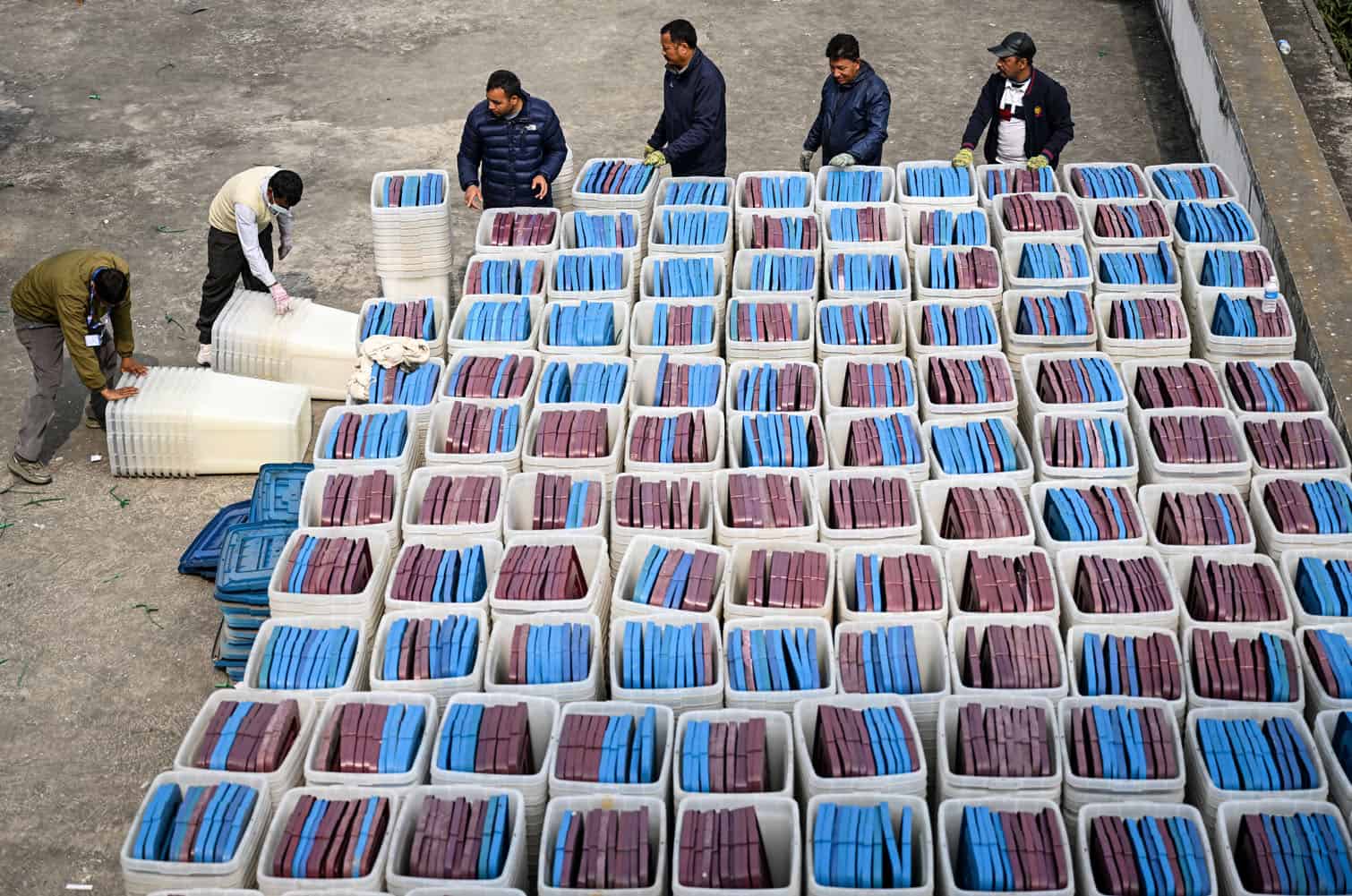 Election officials inspect ballot boxes