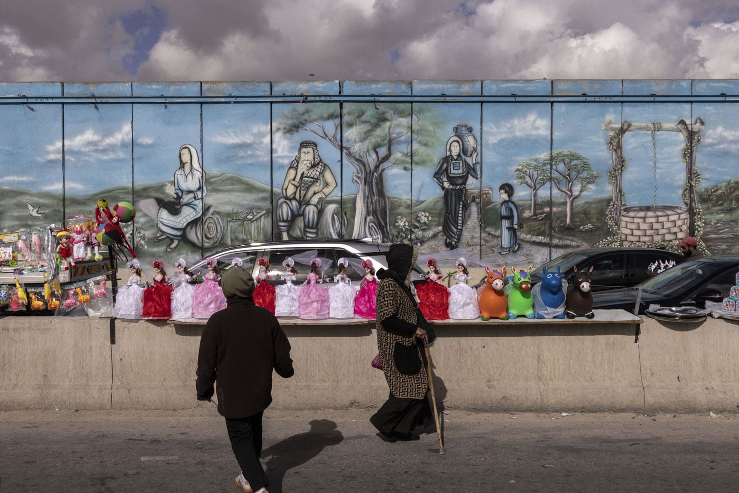Palestinians walk past goods being sold