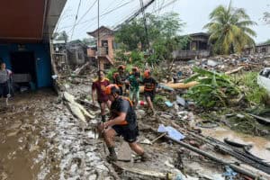 Rescuers evacuate a woman after Tropical Storm Penha hit the area
