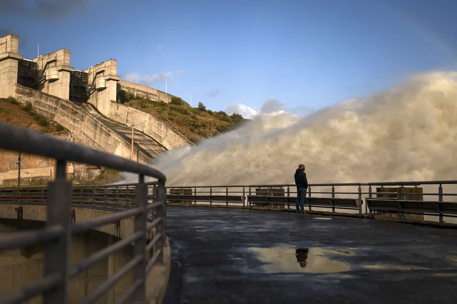 A man looks at the Alqueva dam