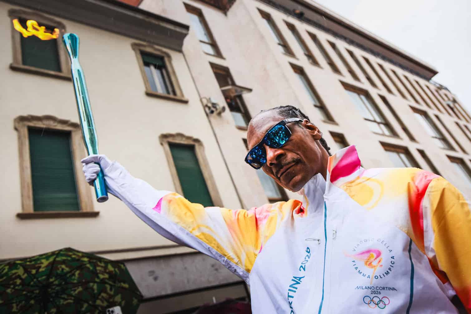 US rapper Snoop Dogg carrying the torch of the Olympic flame