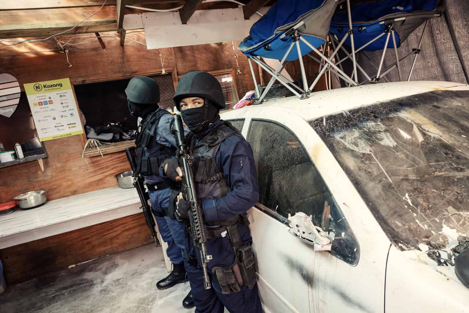 South African policeman stand guard