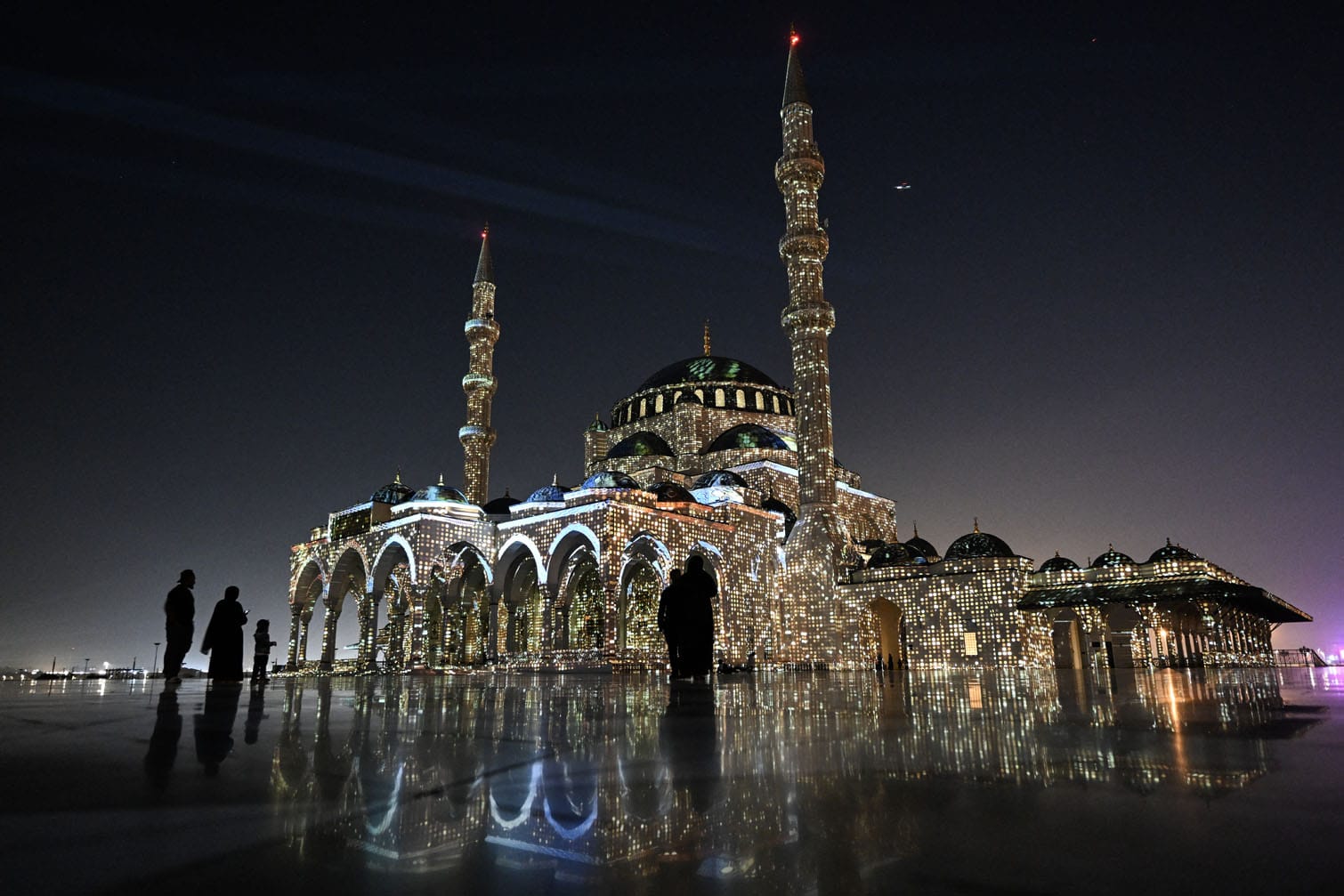 The Sharjah Mosque is lit up in a colourful display