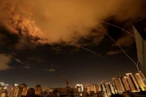 Rocket trails are seen in the sky above the Israeli coastal city of Netanya amid a fresh barrage of Iranian missile attacks on March 25, 2026.