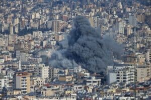 A plume of smoke rises from the site of an Israeli airstrike in the southern suburbs of Beirut's Haret Hreik neighborhood