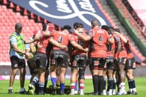 Lions rugby players in a huddle