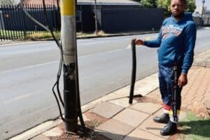 Nico Ntuli shows an example of where electric cables have been stripped.