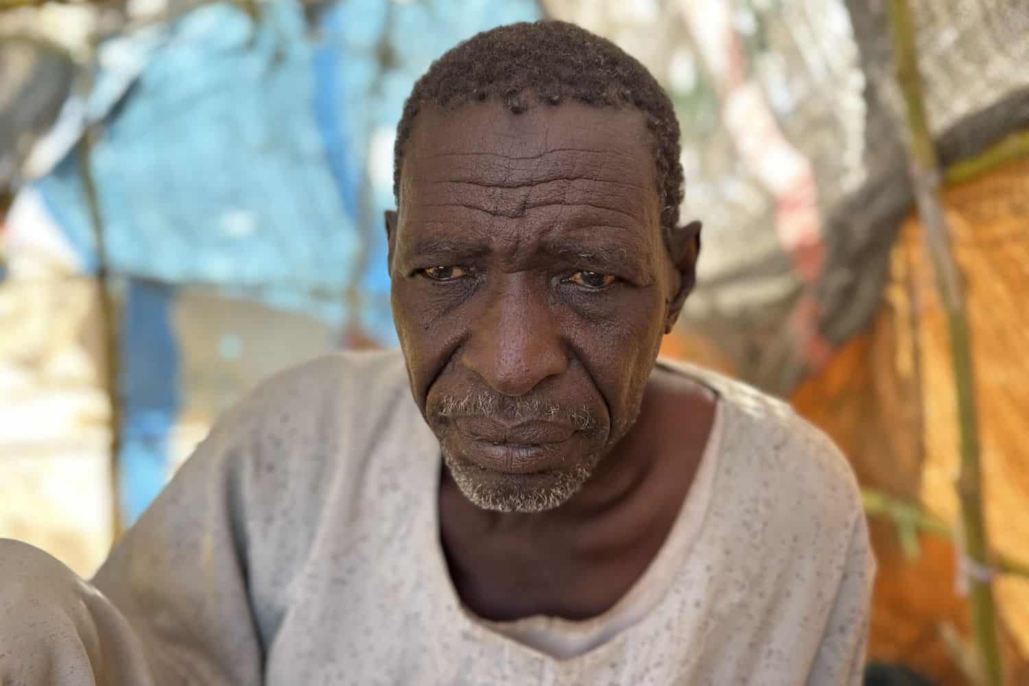 Ahmed Aman, who says he was imprisoned and tortured in Rapid Support Forces' (RSF) prisons before fleeing El-Fasher, sits at a makeshift shelter in the town of Tawila, in war-torn Sudan's western Darfur region on 2 March 2026. Picture: AFP