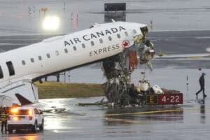 An Air Canada Express CRJ-900 sits on the runway after colliding