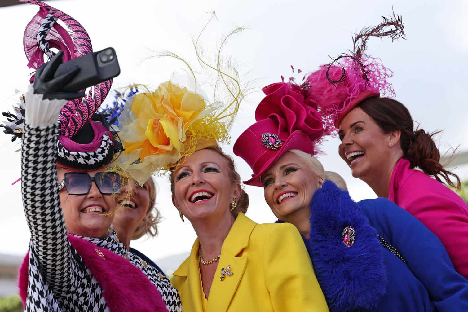 Racegoers pose for photographs