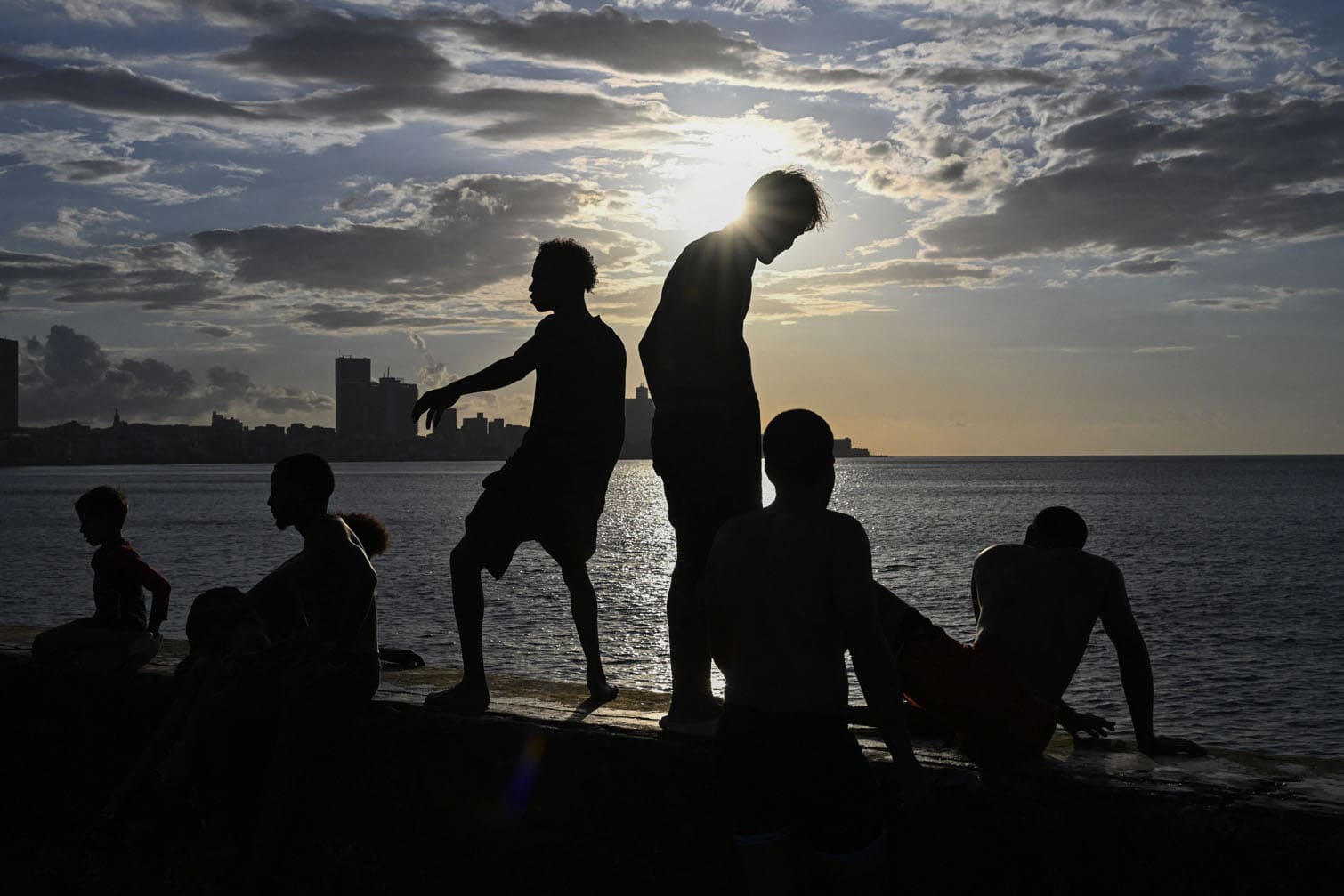 A group of young people enjoy a sunset