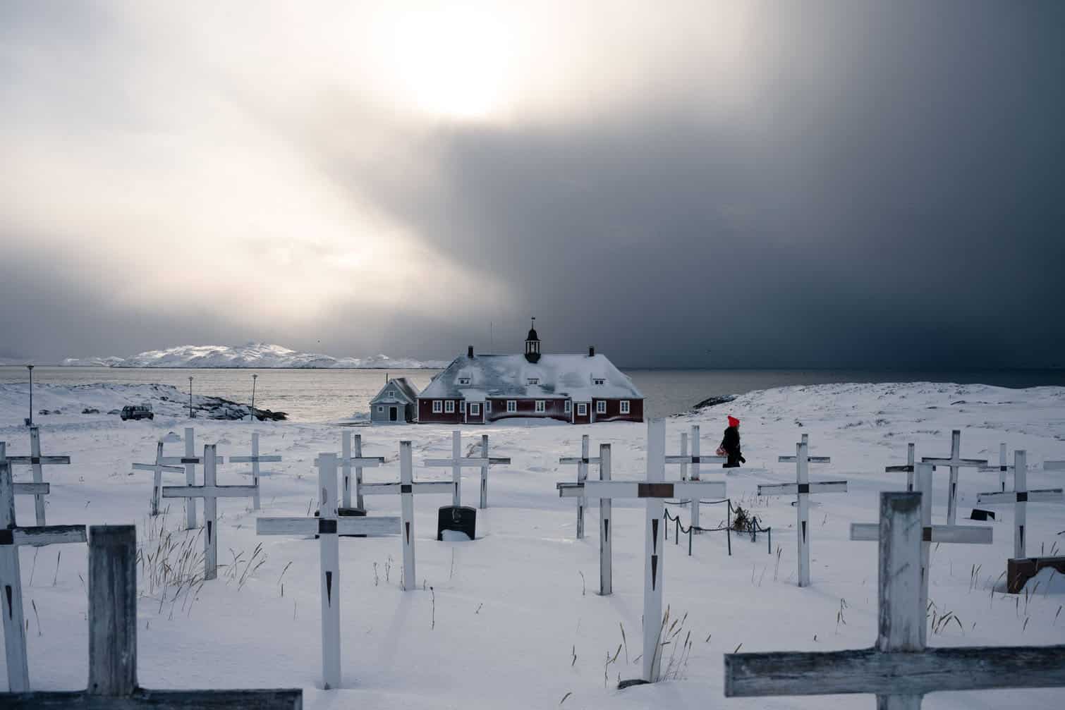 a cemetery and a church lit by sunlight