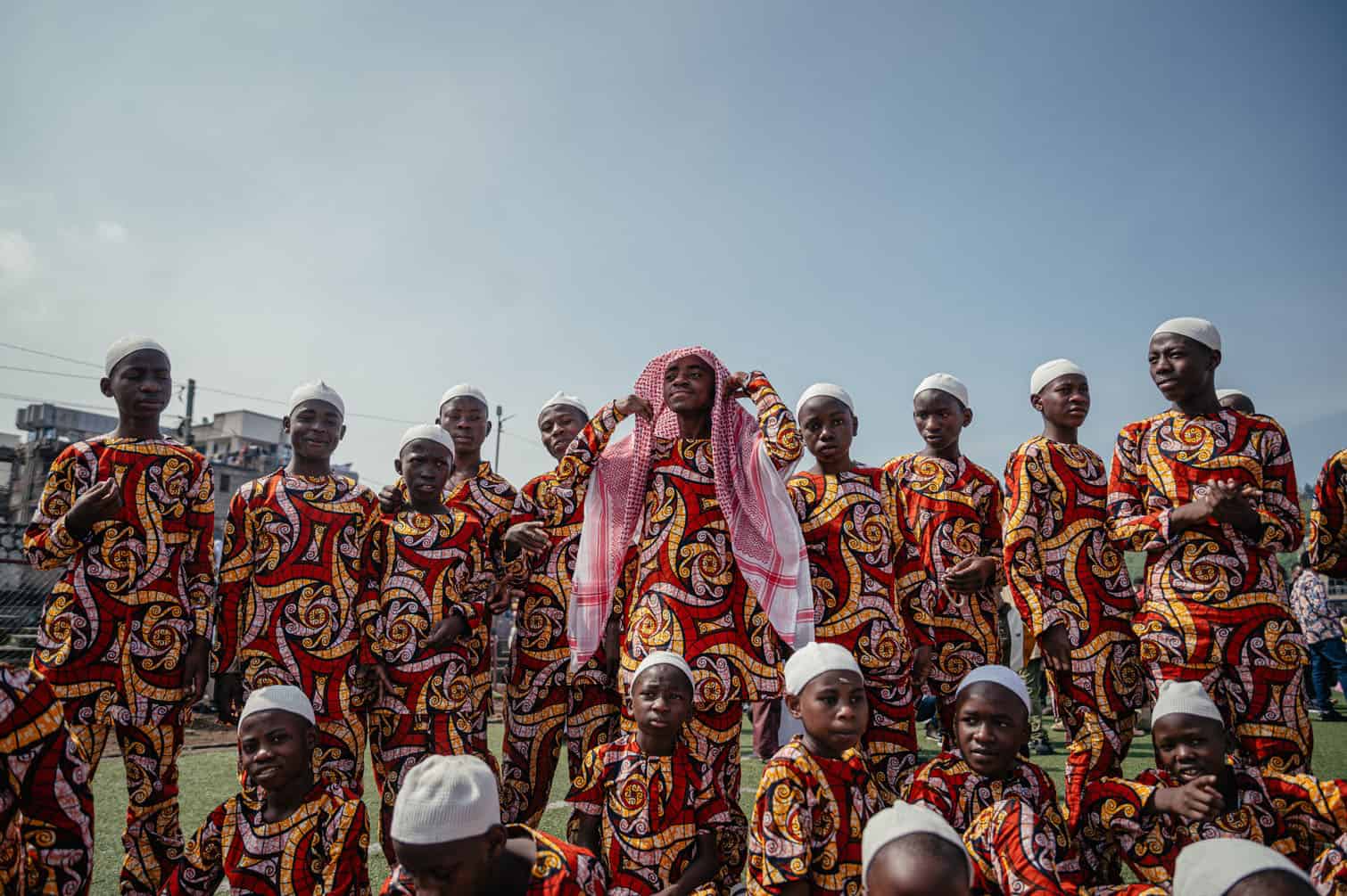 A young Muslim boy dressed in an outfit made from patterned fabric