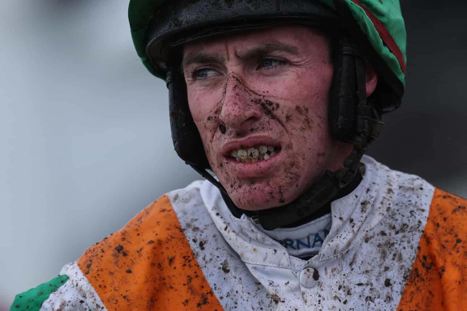 A jockey reacts after competing in the first race