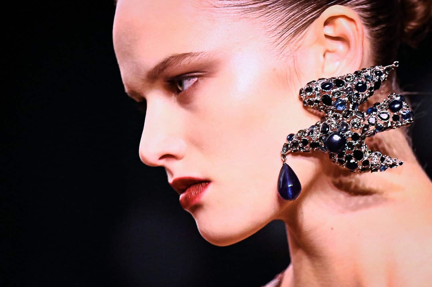 A model presents earings for Saint Laurent