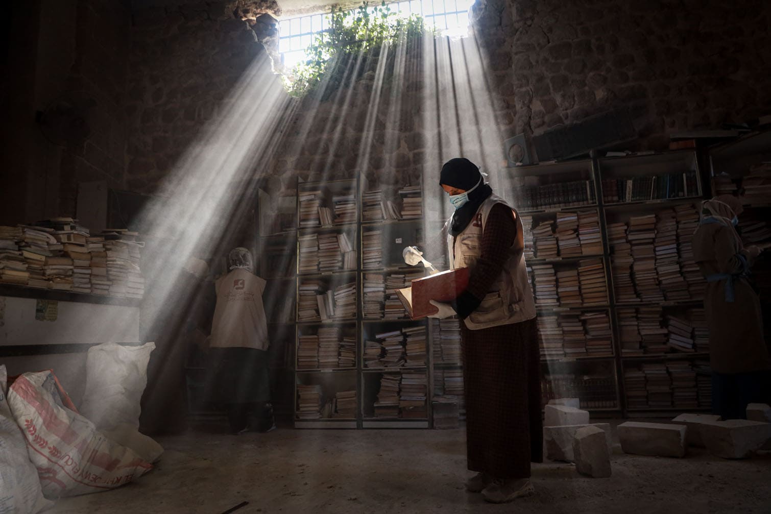 Volunteers work to restore damaged manuscripts at Gazaâs Great Omari Mosque Library