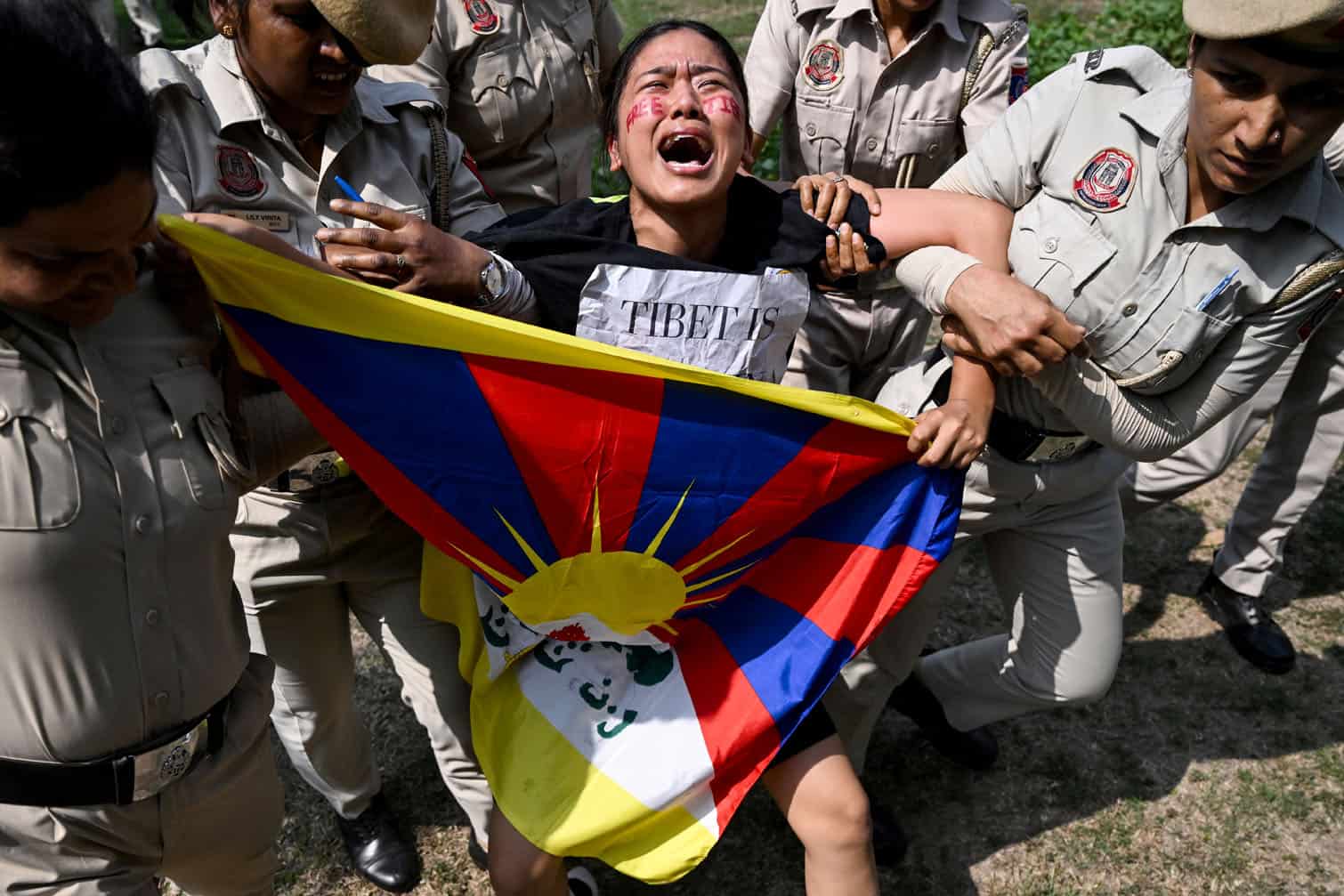 Police detain a protester
