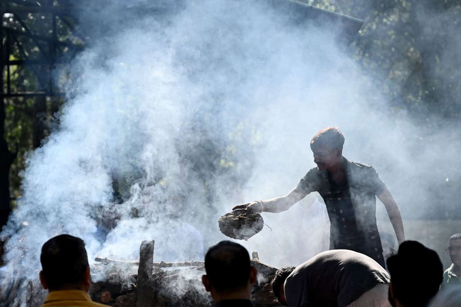 Family members perform the funeral of Harish Rana