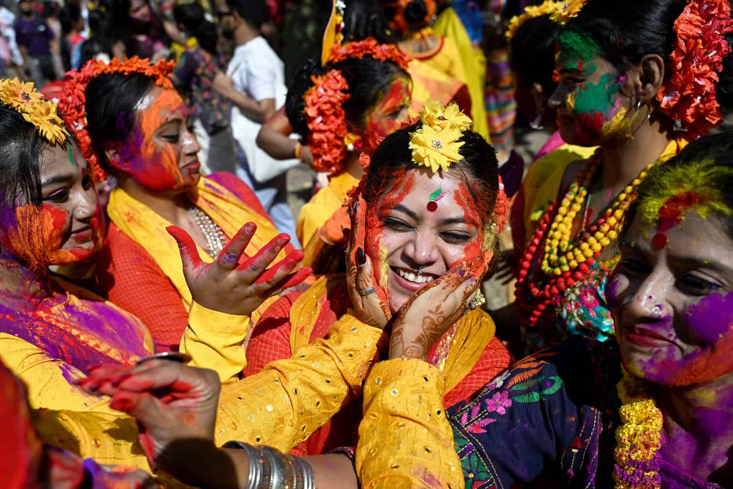 Revellers smear gulal