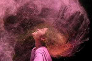 A girl smeared with coloured powder celebrates the Hindu spring festival