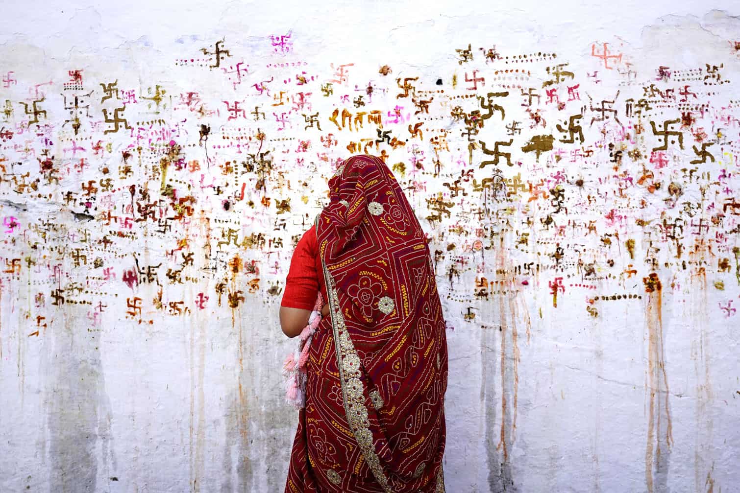 A woman performs rituals for the well being of her family