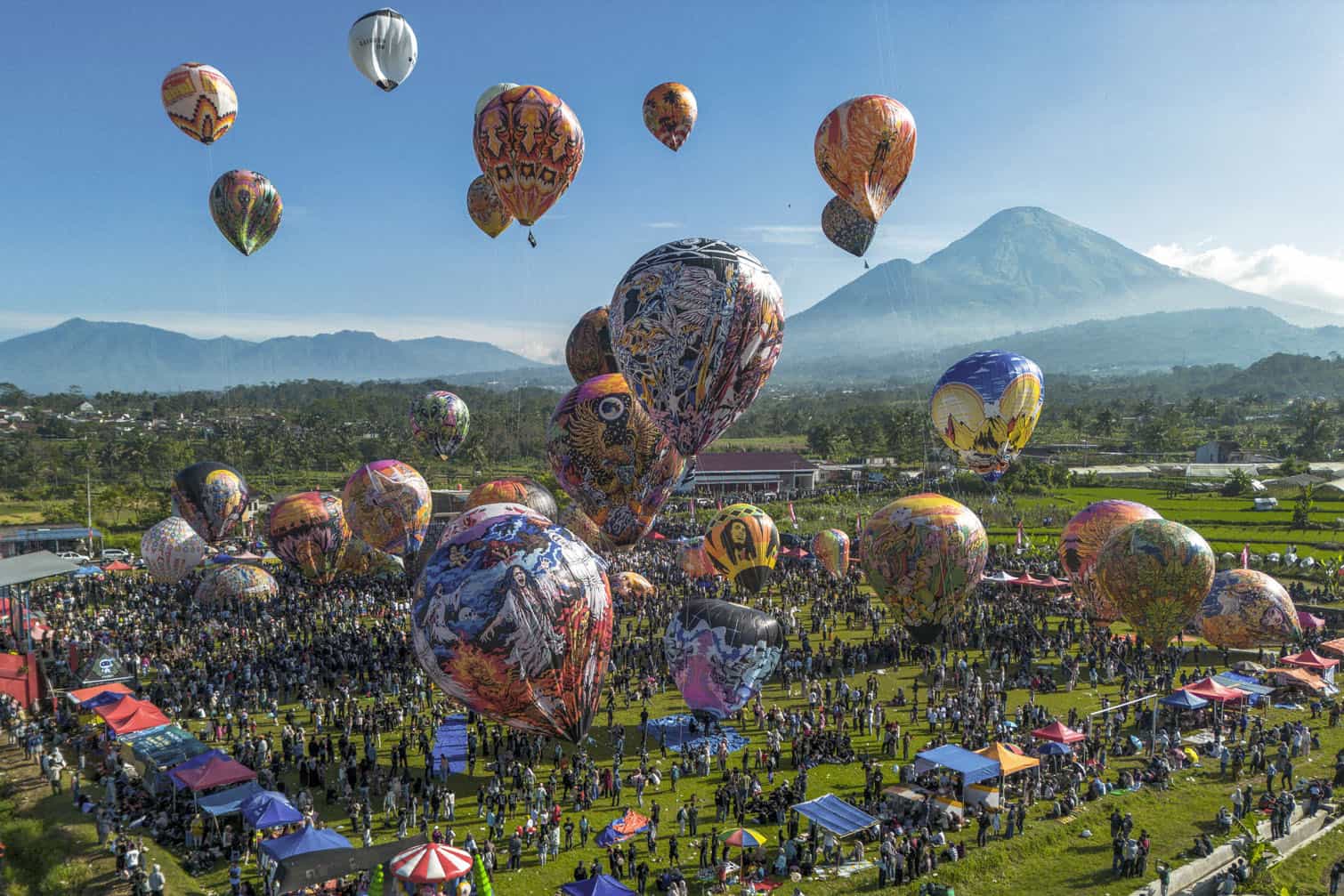An aerial view shows hot air balloons