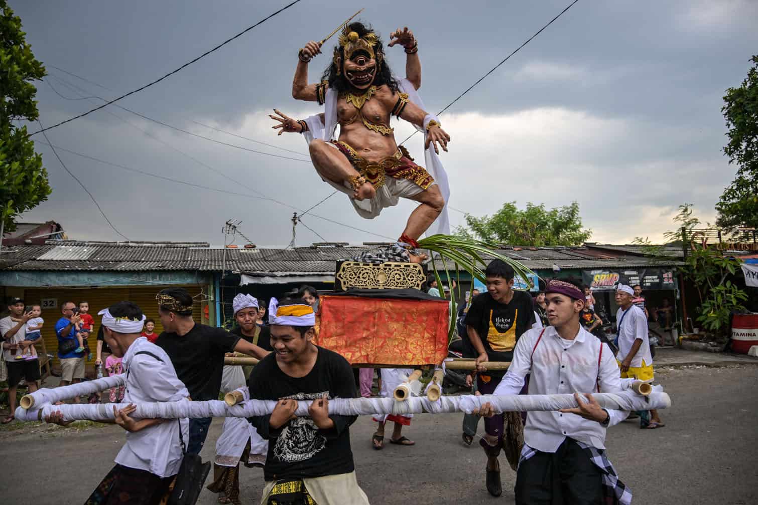 Hindu devotees carry an Ogoh-ogoh