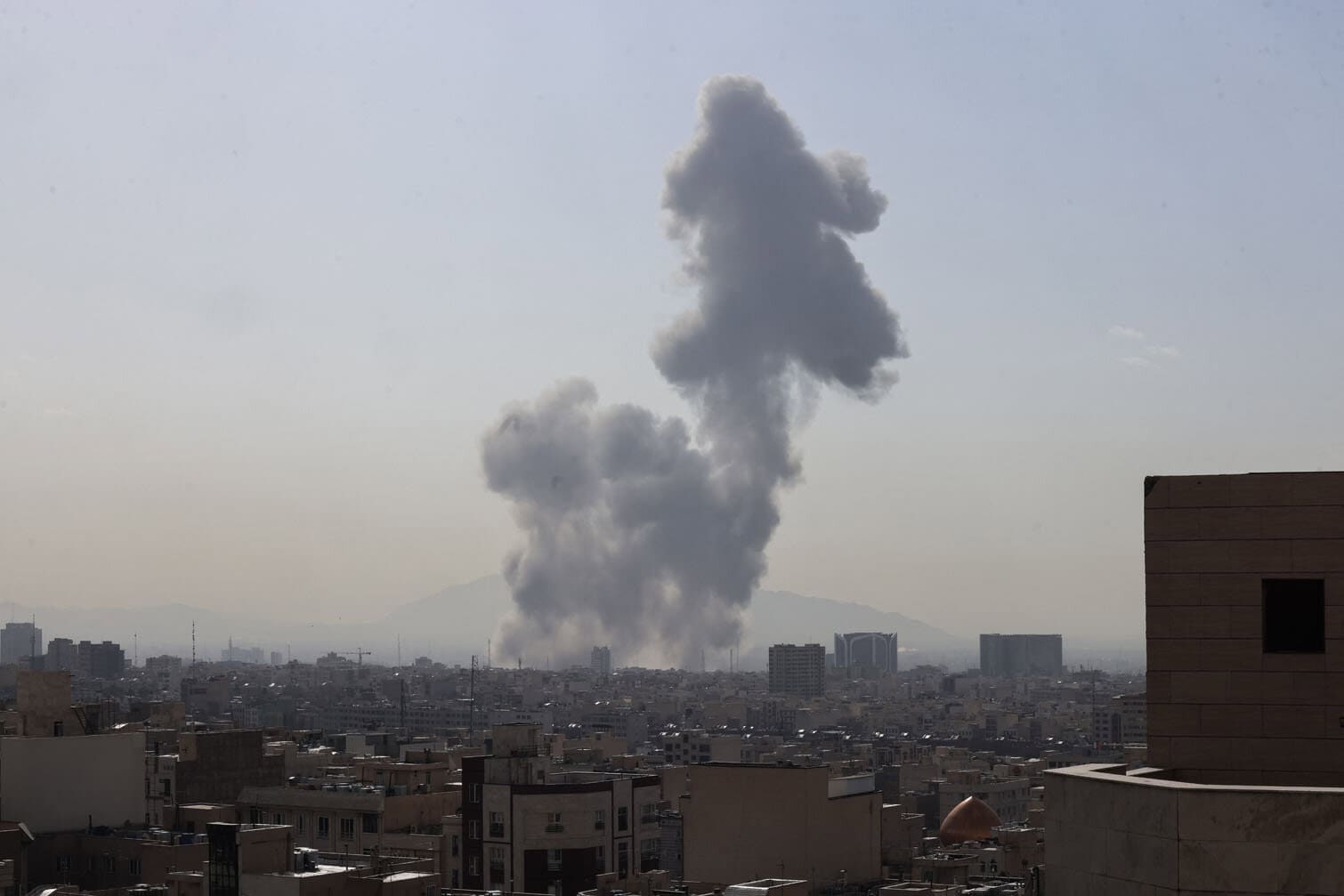 A plume of smoke rises following a reported explosion in Tehran