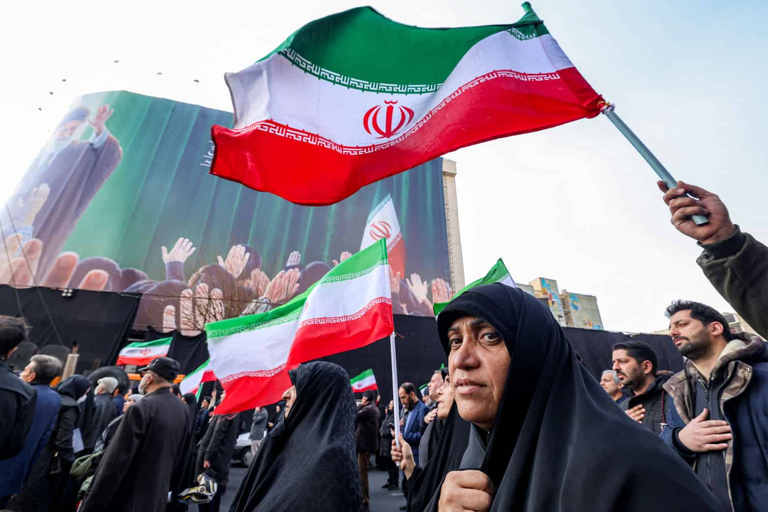Demonstrators gather with Iranian national flags
