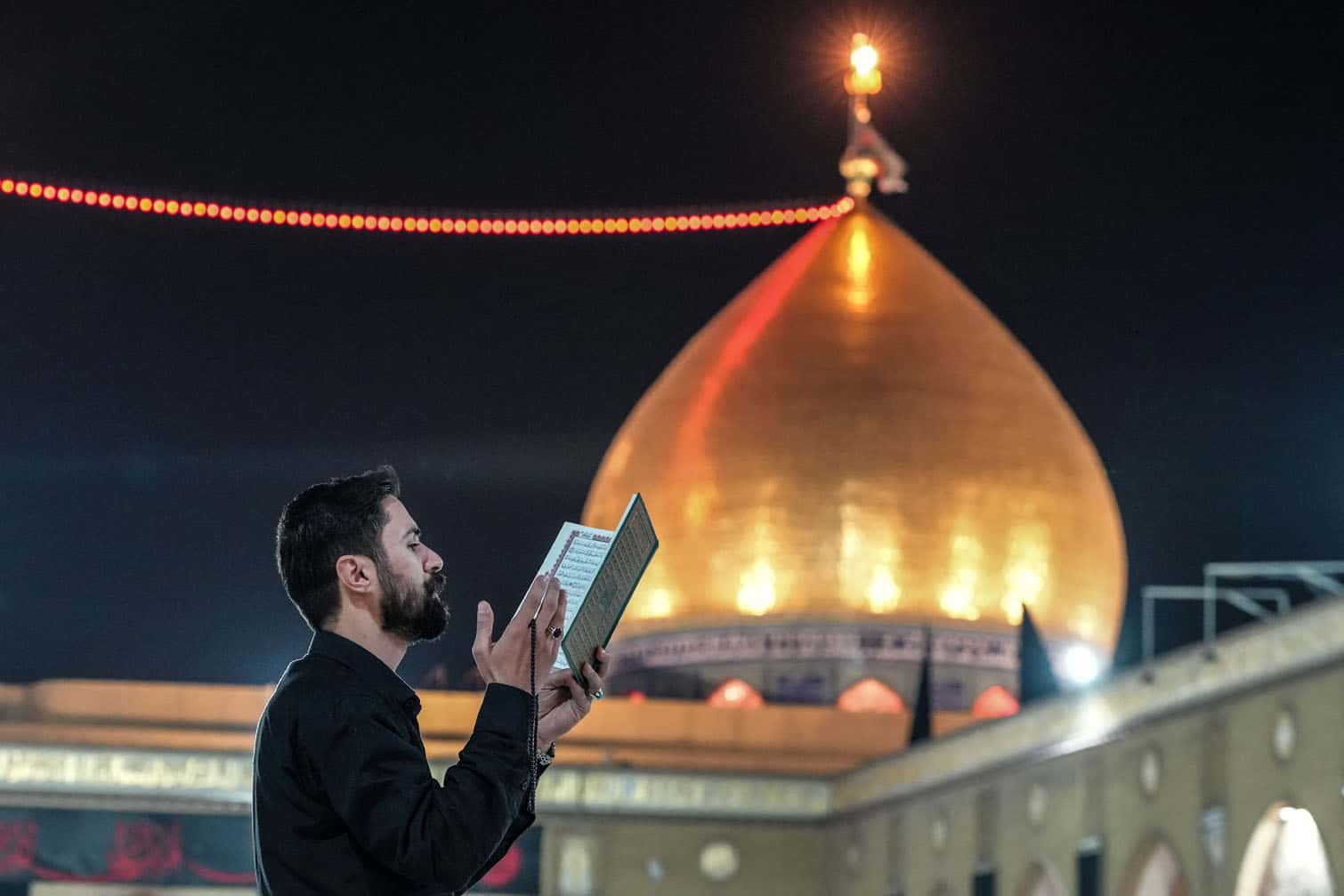 A Shia Muslim recites from a copy of the Quran