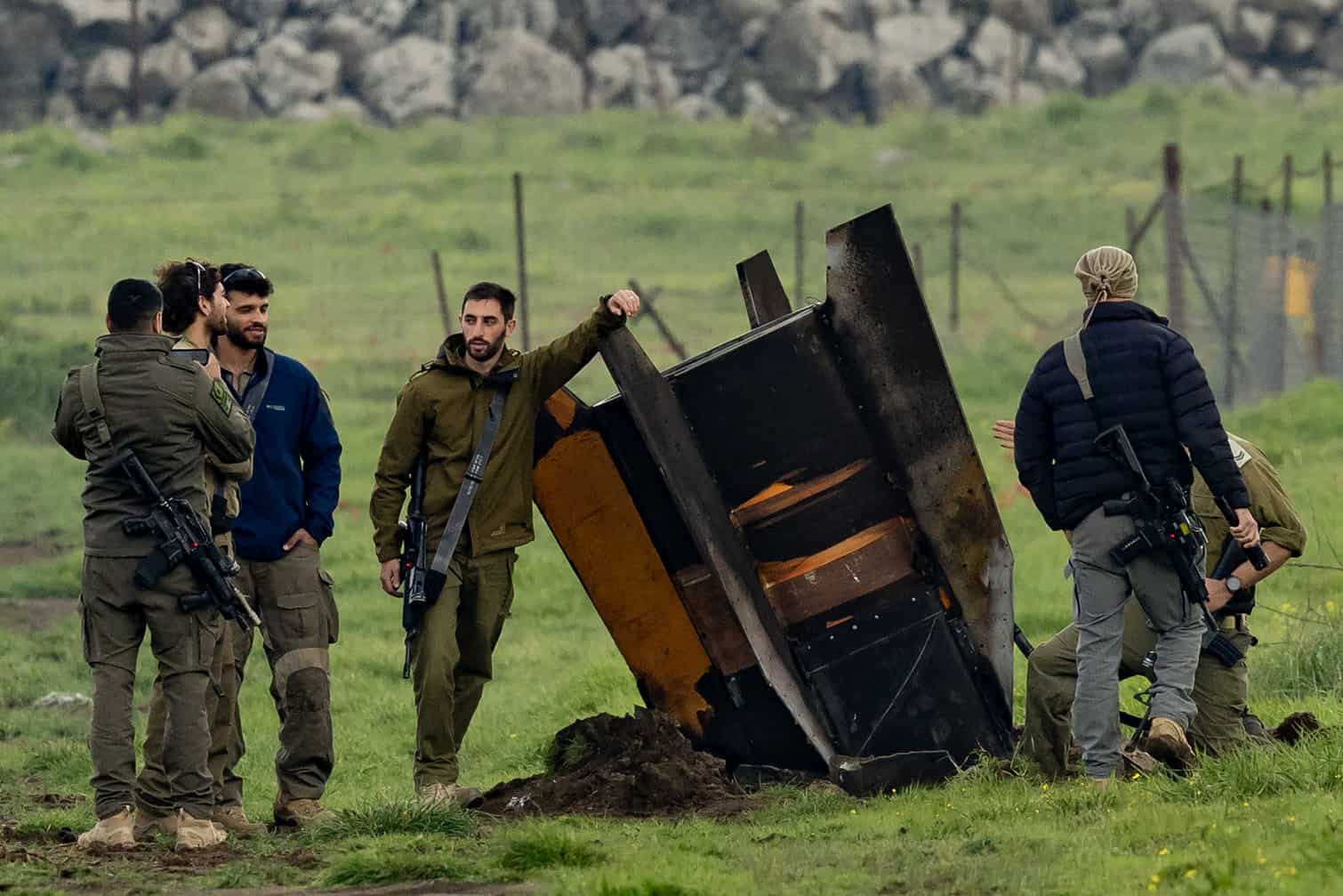Israeli security personnel secure an area around a rocket