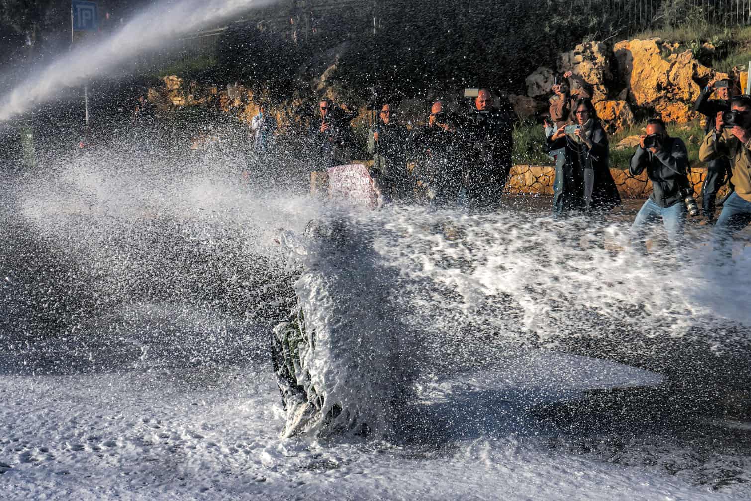 Israeli security forces use water cannon to disperse protesters