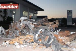 The charred wreckage at the dealership.
