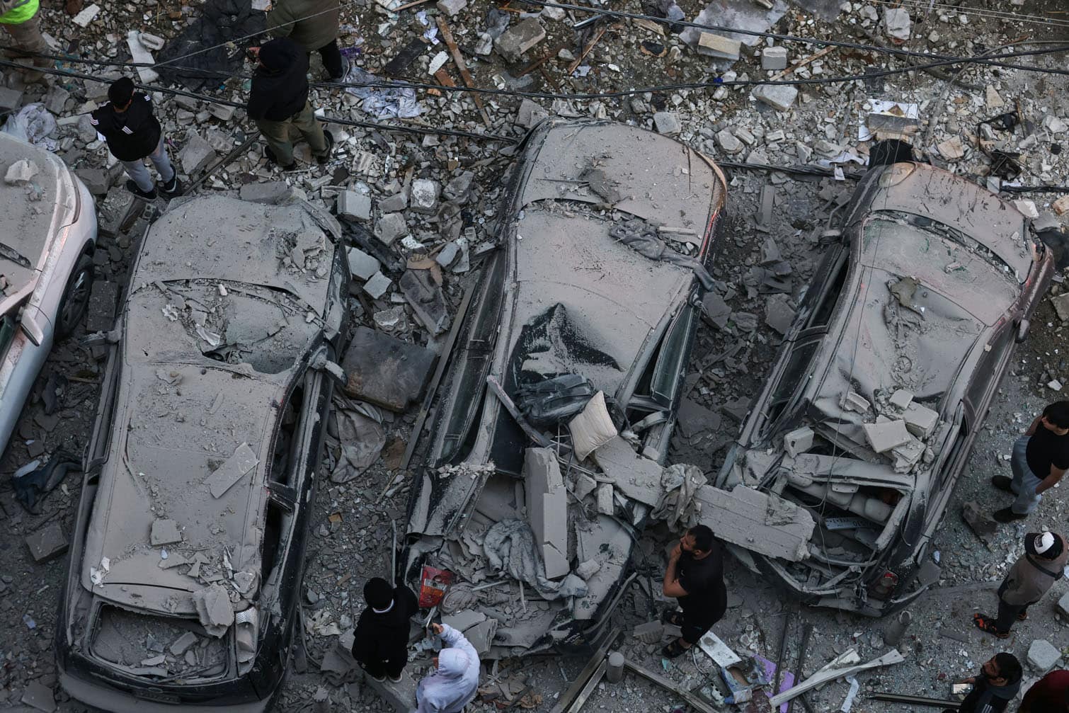 Residents gather at the site of an Israeli airstrike