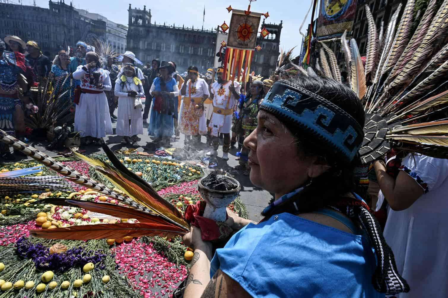 An indigenous woman looks on as she participates in a ceremony