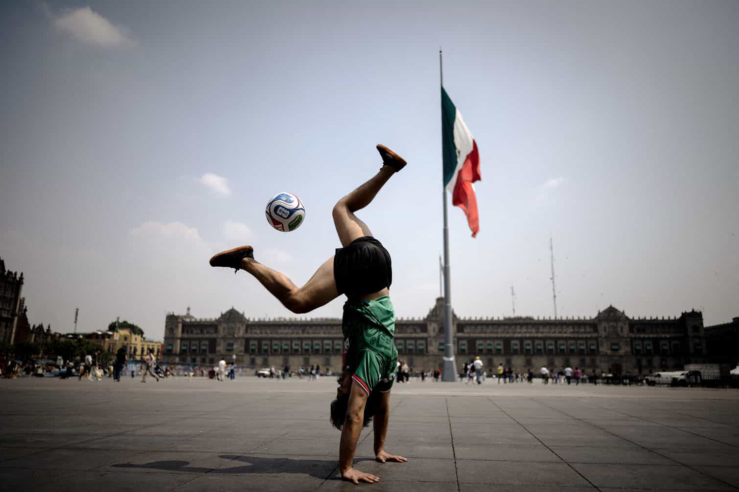 A young woman plays freestyle with a football