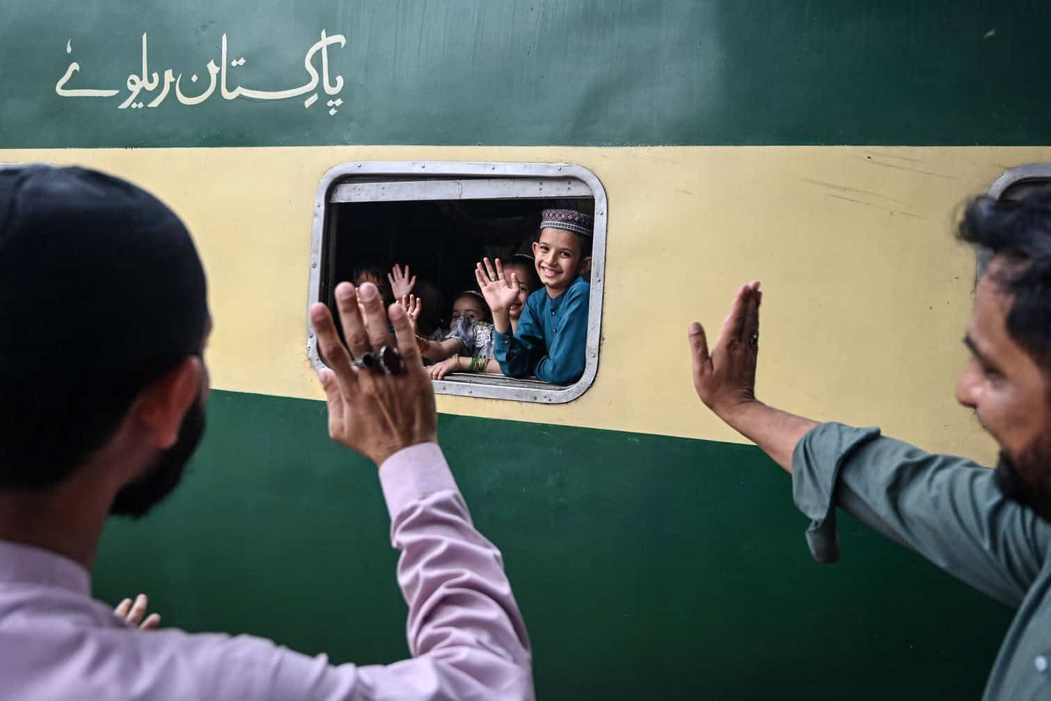 Children wave towards their family members