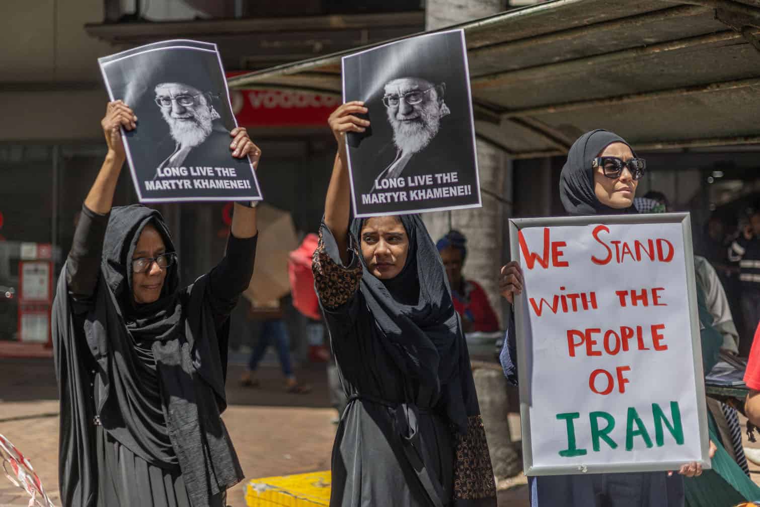 Protesters hold portraits of Iran's late supreme leader Ayatollah Ali Khamenei