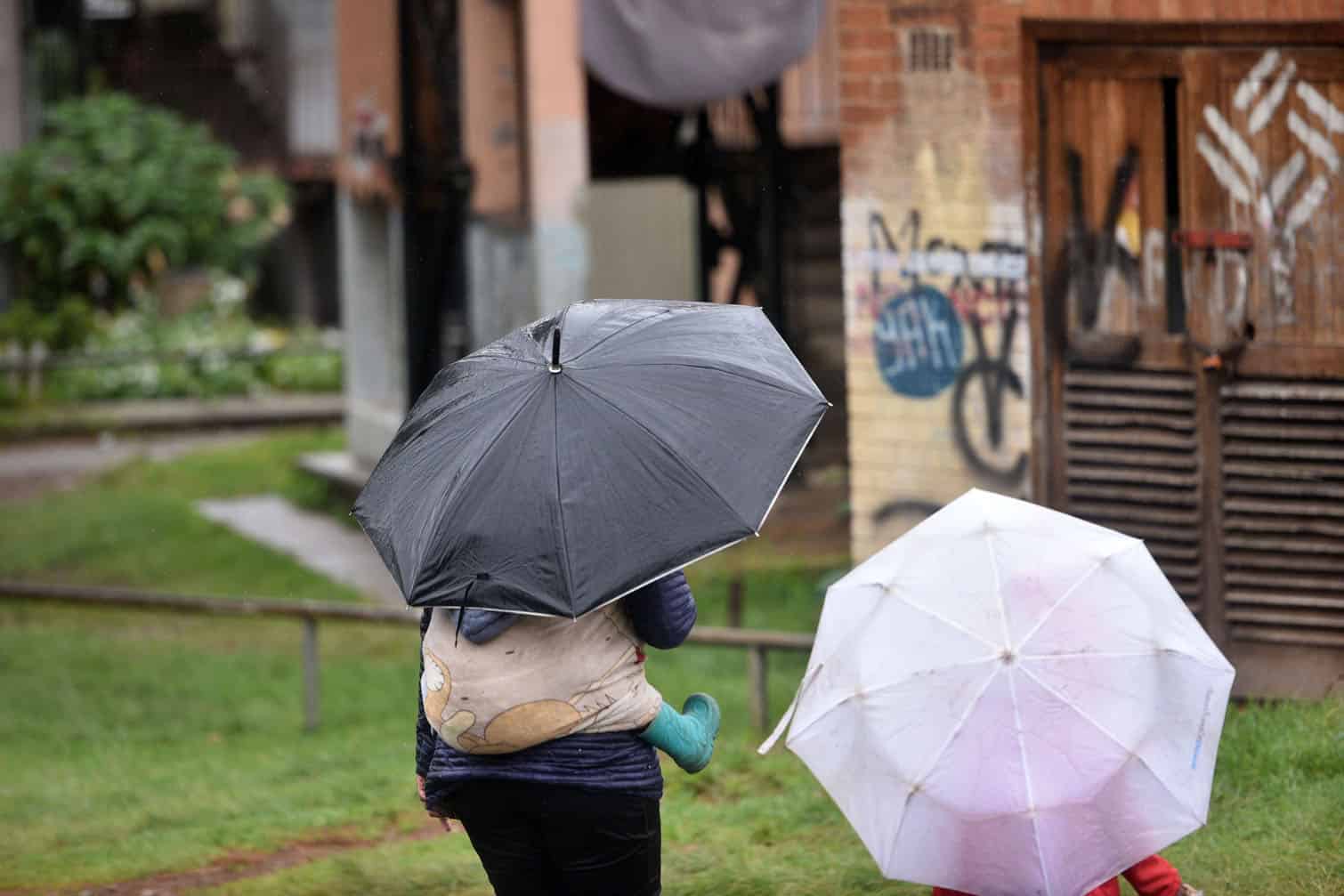A woman and child brave the rain