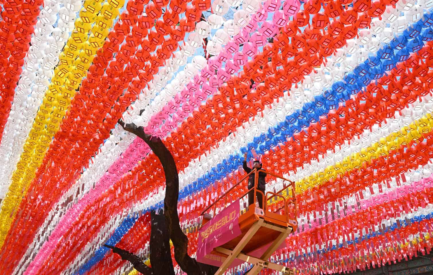 A temple worker attaches name cards