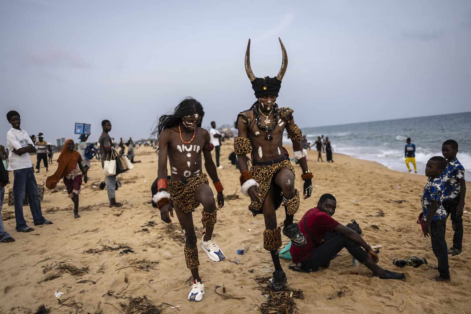 Performers walk on the beach