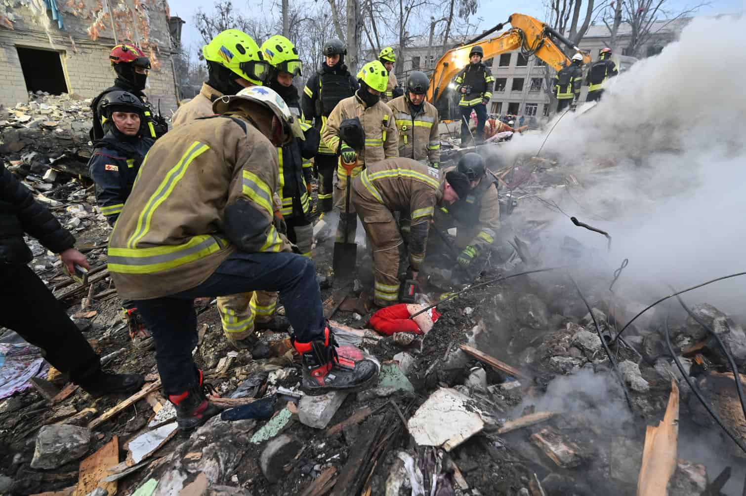 Rescuers retrieve a body from under the rubbles