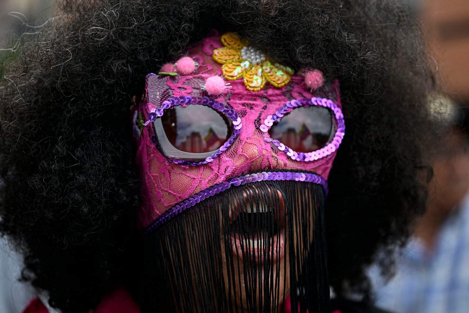 A masked woman shouts slogans during a demonstration
