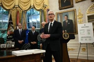 Apple CEO Tim Cook speaks as US President Donald Trump (2nd R), Commerce Secretary Howard Lutnick (2nd L) and Treasury Secretary Scott Bessent (L) look on in the Oval Office of the White House in Washington, DC, on August 6, 2025 to announce that Apple will invest an additional $100 billion in the United States, taking its total pledge to $600 billion over the next four years. Apple announced on April 20, 2026 that Cook would step down in September, handing the chief executive job to company veteran John Ternus. Picture via Brendan SMIALOWSKI / AFP