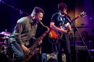 United States' saxophonist Ravi Coltrane (L) performs on the stage of the Impart jazz club in Wroclaw during his concert with trumpeter and composer Terence Blanchard in honor of Miles Davis and John Coltrane as part of the Jazz nad Odra festival on April 26, 2026. Awash in purple and turquoise stage lights, a century after the birth of two of jazz's most formidable legacies -- Miles Davis and John Coltrane -- Ravi Coltrane and Terence Blanchard are refusing to recreate the past. Picture Wojtek RADWANSKI / AFP