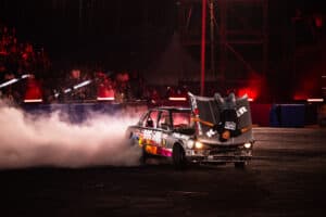 Spinner hanging off his bonnet of his car