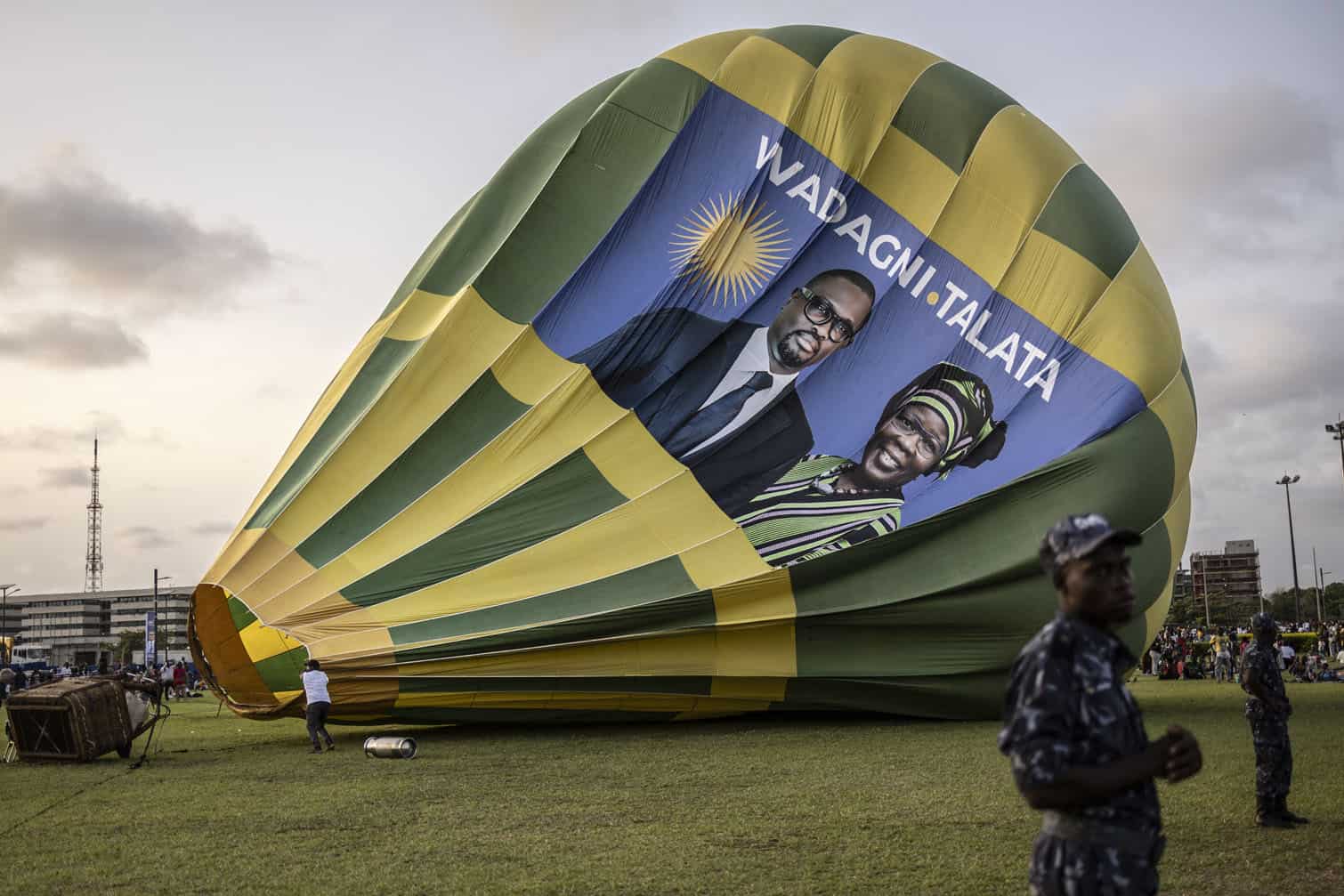 People walk past a deflating hot air balloon