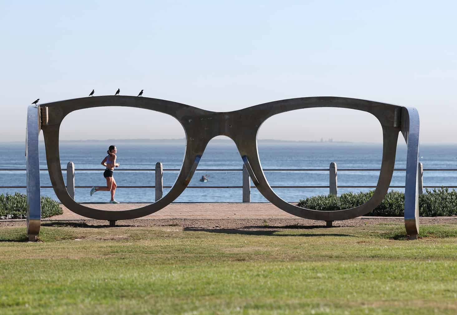 A women runs along the Sea Point Promenade