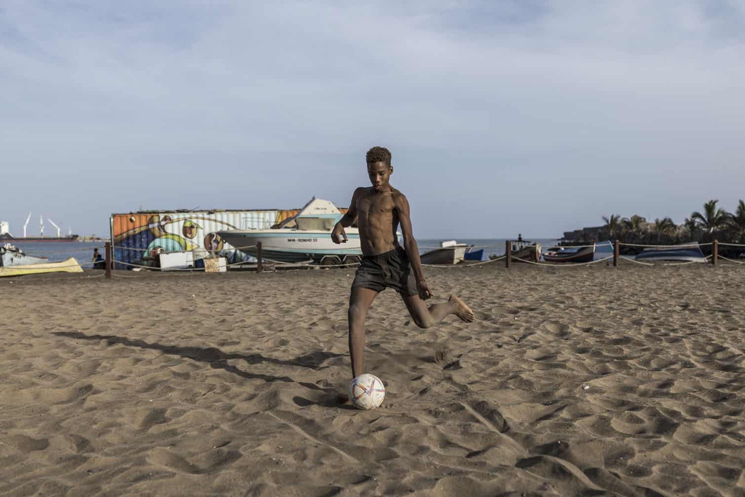 A boy attempts a free kick