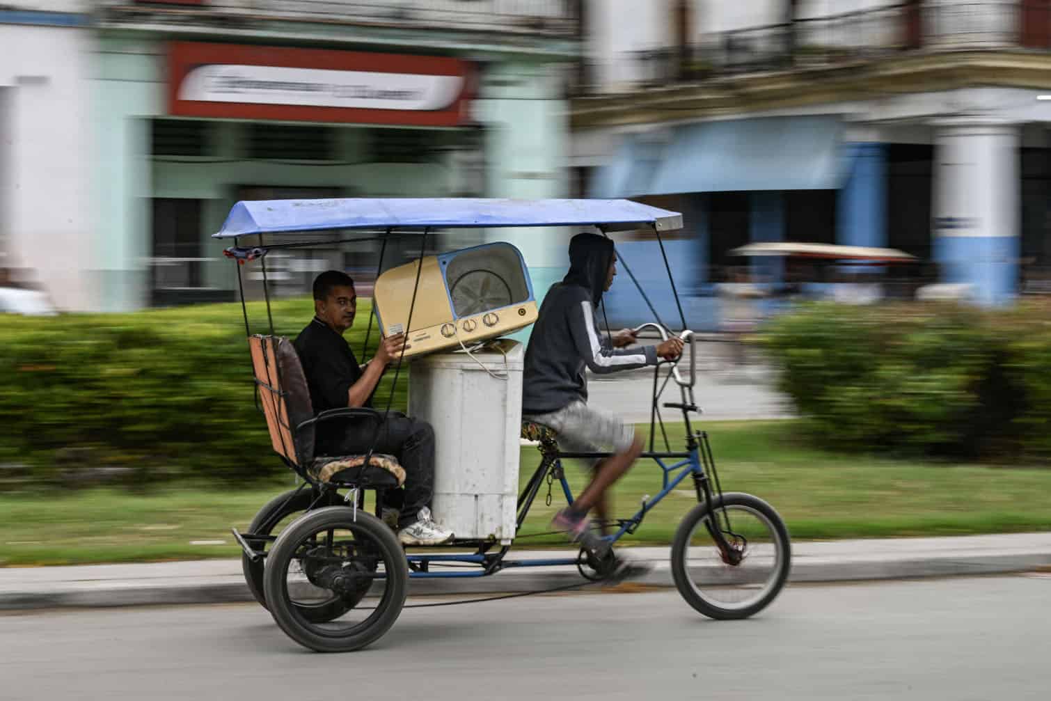 A man transports washing machines